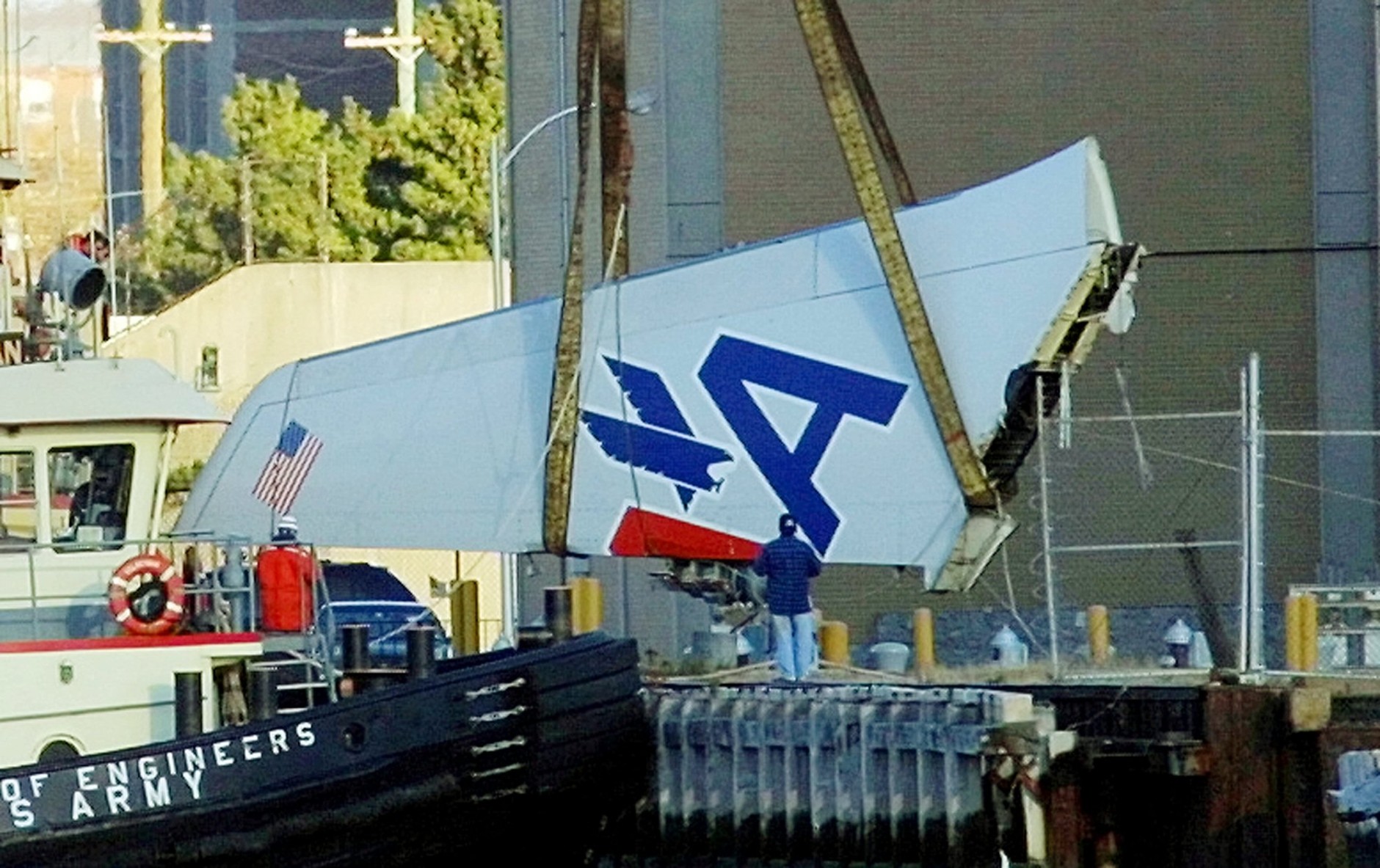 A large section of the tailpiece of American Airlines Flight 587 is lifted off a boat by a crane after the Airbus A300 crashed in the Rockaway Beach section of the Queens borough of New York Monday, Nov. 12, 2001. The tailpiece was recovered from Jamaica Bay and towed to shore. (AP Photo/Daniel P. Derella)