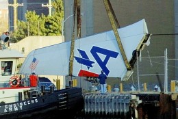 A large section of the tailpiece of American Airlines Flight 587 is lifted off a boat by a crane after the Airbus A300 crashed in the Rockaway Beach section of the Queens borough of New York Monday, Nov. 12, 2001. The tailpiece was recovered from Jamaica Bay and towed to shore. (AP Photo/Daniel P. Derella)