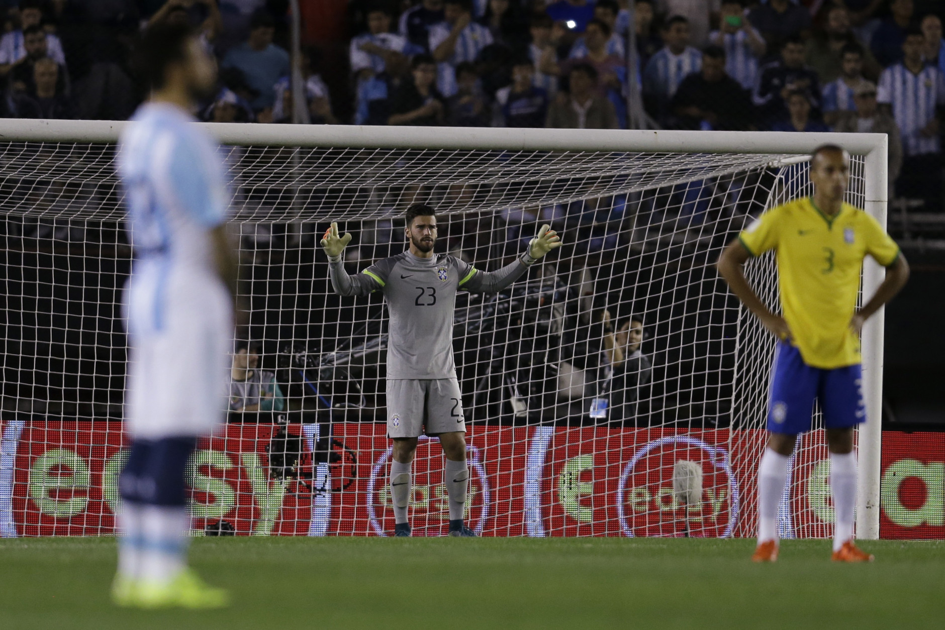 Brazil's goalkeeper Alisson, center, defender Miranda, right, and Argentina's Ezequiel Lavezzi observe a minute of silence to pay respect to the victims of the Paris attacks prior to a 2018 World Cup qualifying soccer match in Buenos Aires, Argentina, Friday, Nov. 13, 2015. Several dozen people were killed in attacks around Paris on Friday, French President Francois Hollande said, announcing that he was closing the countrys borders and declaring a state of emergency. (AP Photo/Victor R. Caivano)