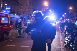 Elite police officers arrive outside the Bataclan theater  in Paris, France, Wednesday, Nov. 13, 2015. Several dozen people were killed in a series of unprecedented attacks around Paris on Friday, French President Francois Hollande said, announcing that he was closing the country's borders and declaring a state of emergency. (AP Photo/Kamil Zihnioglu)