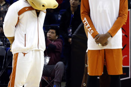 Prince Ibeh of the Texas Longhorns observes a moment of silence near the team mascot to mark the attacks in Paris before a match against the Washington Huskies at the Mercedes Benz Arena in Shanghai, China, Saturday, Nov. 14, 2015. (AP Photo/Ng Han Guan)