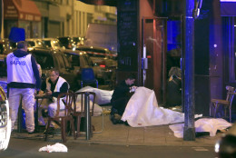 RETRANSMISSION FOR ALTERNATIVE CROP - Victims lay on the pavement outside a Paris restaurant, Friday, Nov. 13, 2015.  Police officials in France on Friday report multiple terror incidents, leaving many dead.  It was unclear at this stage if the events are linked. (AP Photo/Thibault Camus)