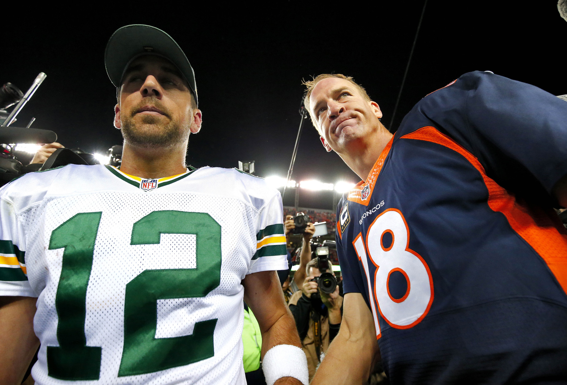 Denver Broncos quarterback Peyton Manning (18) and Green Bay Packers quarterback Aaron Rodgers (12) meet at midfield after an NFL football game, Sunday, Nov. 1, 2015, in Denver. The Broncos won 29-10 to improve to 7-0. (AP Photo/Jack Dempsey)