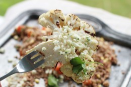This June 8, 2015 photo shows grilled cauliflower steaks with lemon lime feta gremolata in Concord, N.H. Cauliflower is a veggie steak favorite, its flavor enhanced by the high heat of grilling or roasting, which coax out a sweet earthiness. (AP Photo/Matthew Mead)
