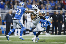 Oakland Raiders wide receiver Seth Roberts (10) catches a pass defended by Detroit Lions cornerback Darius Slay (23) and strong safety Isa Abdul-Quddus (42) during the second half of an NFL football game, Sunday, Nov. 22, 2015, in Detroit. (AP Photo/Rick Osentoski)