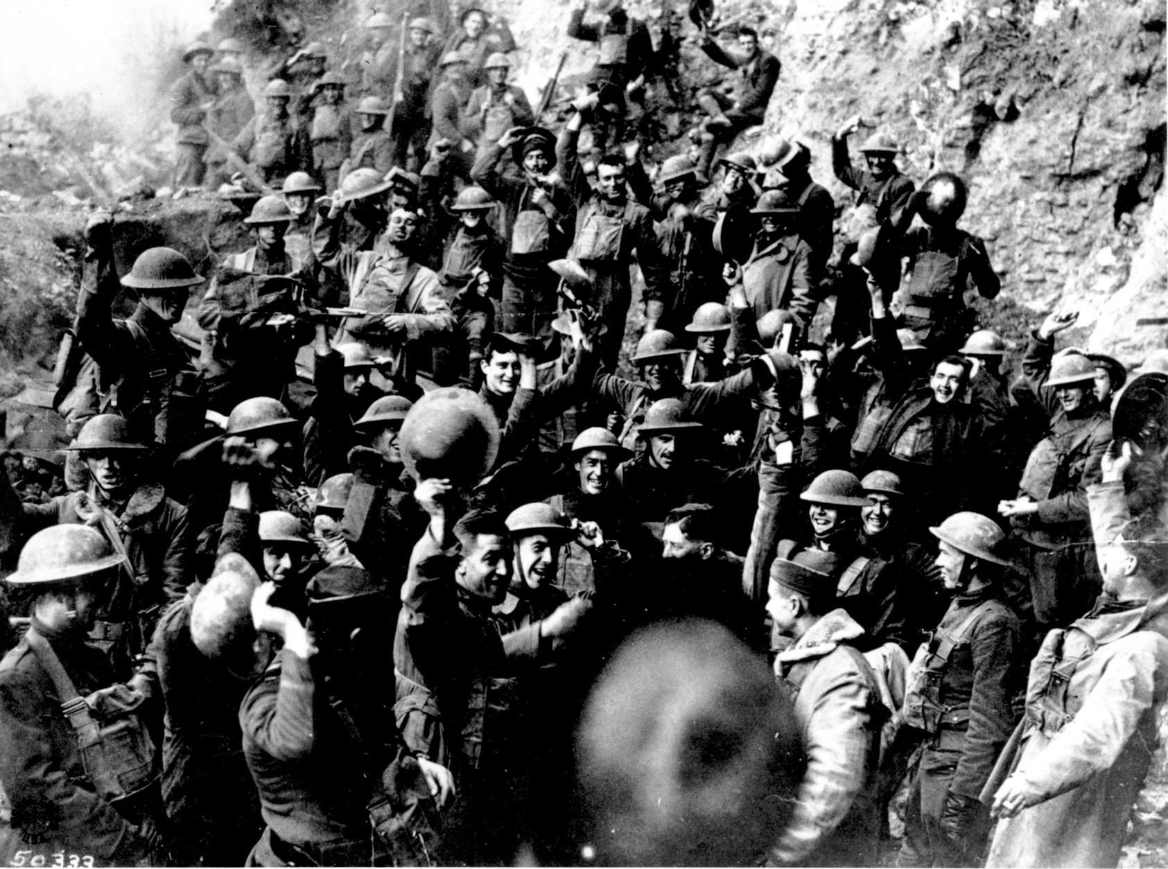 American troops cheer after hearing the news that the Armistice has been signed, ending World War I in Nov. 1918.  They are located on the front northeast of St. Mihiel, France.  Similar celebrations took place all along the line where the Americans were engaged in an offensive. (AP photo)