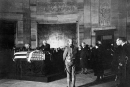 President Warren G. Harding places a wreath on the casket of an unknown soldier from World War I in the rotunda of the U.S. Capitol, Nov. 11, 1921 in Washington. (AP Photo)