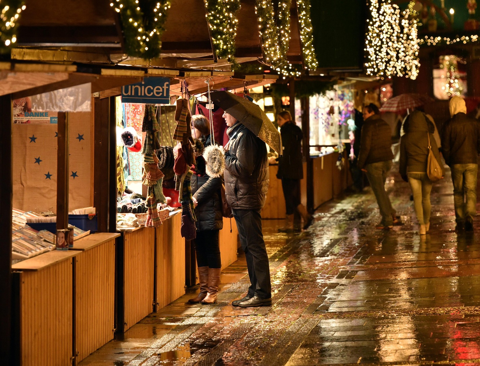 Only a few people came to the opening of the traditional Christmas market in Essen, Germany, Thursday, Nov. 19, 2015. The markets, favorites among locals and tourists for decorations and mulled wine, are feared to be possible targets for attacks. (AP Photo/Martin Meissner)