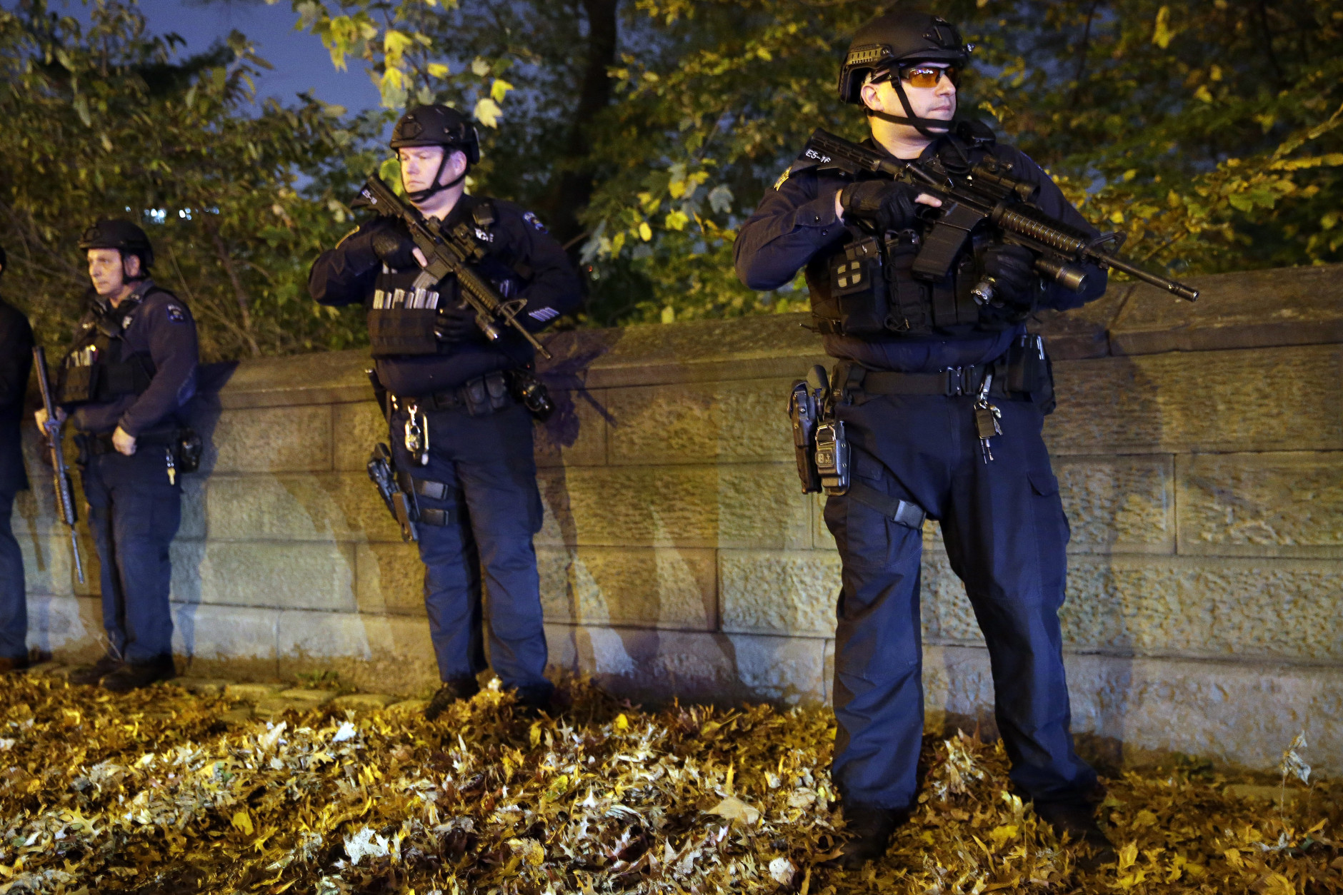 Heavily armed New York City police officers stand guard across the street from the French consulate on New York's Fifth Ave., Friday, Nov. 13, 2015. Police in New York say they've deployed extra units to crowded areas of the city "out of an abundance of caution" in the wake of the attacks in Paris, France. A New York Police Department statement released Friday stressed police have "no indication that the attack has any nexus to New York City."(AP Photo/Mary Altaffer)