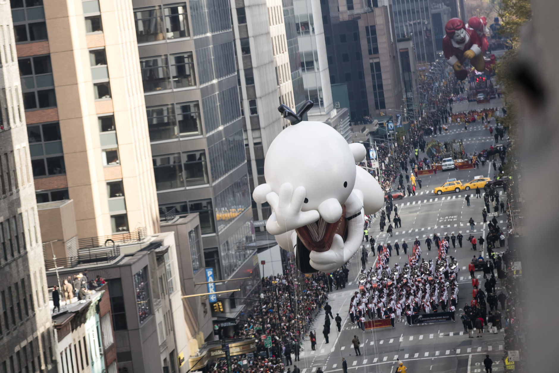 A Diary of a Wimpy Kid balloon goes down 6th Avenue for the 89th annual Macy's Thanksgiving Day Parade as seen from above street level on Thursday, Nov. 26, 2015, in New York. (Photo by Ben Hider/Invision/AP)