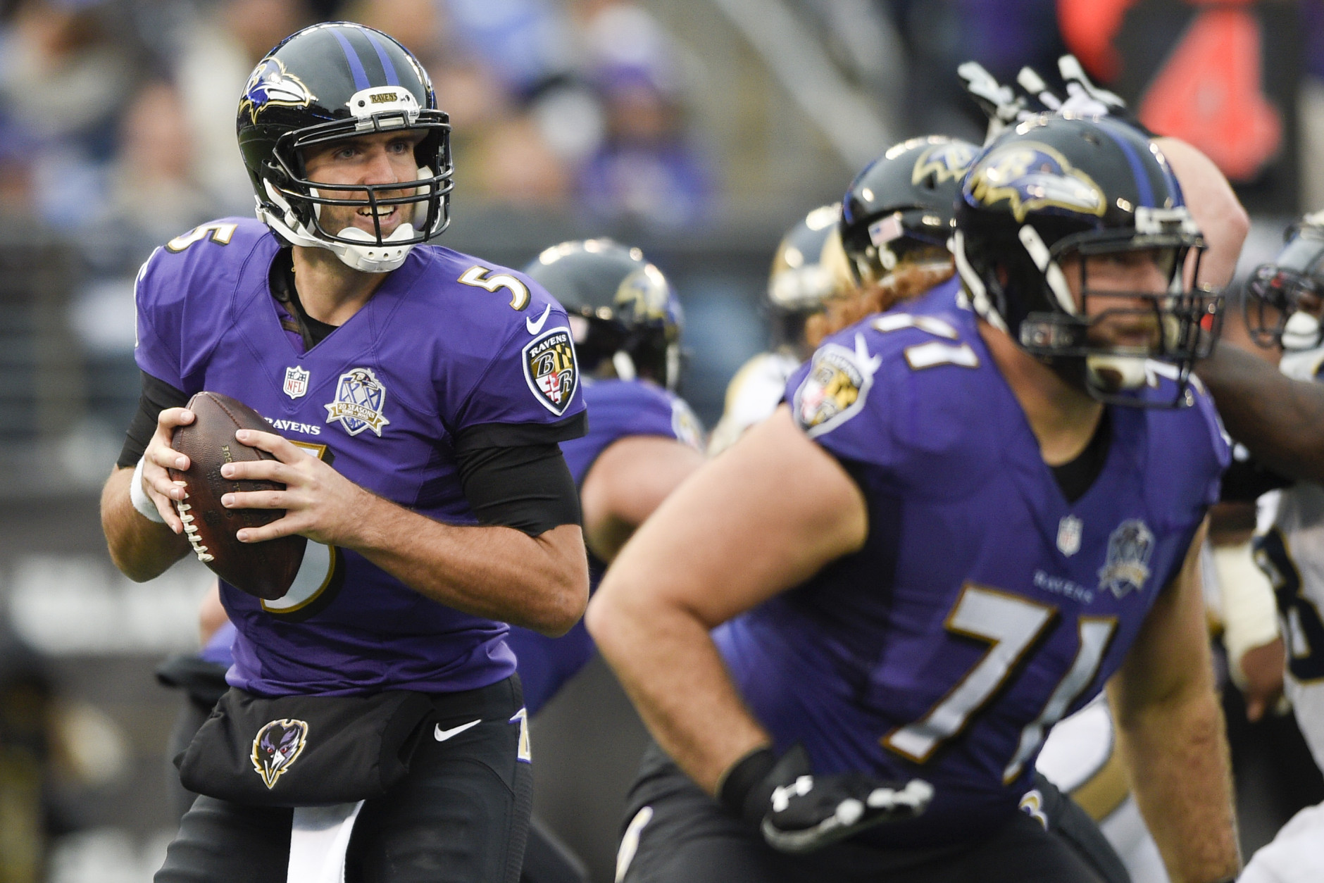 Baltimore Ravens quarterback Joe Flacco (5) turns out of the pocket looking for an open man during the second half of an NFL football game against the St. Louis Rams in Baltimore, Sunday, Nov. 22, 2015. Flacco was injured in the closing minutes of the Ravens 16-13 win over the St. Louis Rams. (AP Photo/Nick Wass)
