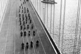 In this Nov. 12, 1936 photo, State Highway policemen cross the western span of the San Francisco-Oakland Bay Bridge during its opening in San Francisco.  The project cost  $77.6 million. The bridge has been closed indefinitely after a rod installed during last month's emergency repairs snapped, Tuesday, Oct. 27, 2009, causing a traffic nightmare for the 280,000 motorists who cross the landmark span every day. (AP Photo)