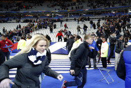 Spectators invade the pitch of the Stade de France stadium after the international friendly soccer match between France and Germany in Saint Denis, outside Paris, Friday, Nov. 13, 2015. Hundreds of people spilled onto the field of the Stade de France stadium after explosions were heard nearby during a friendly match between the French and German national soccer teams. French President Francois Hollande says he is closing the country's borders and declaring a state of emergency after several dozen people were killed in a series of unprecedented terrorist attacks.  (AP Photo/Christophe Ena)