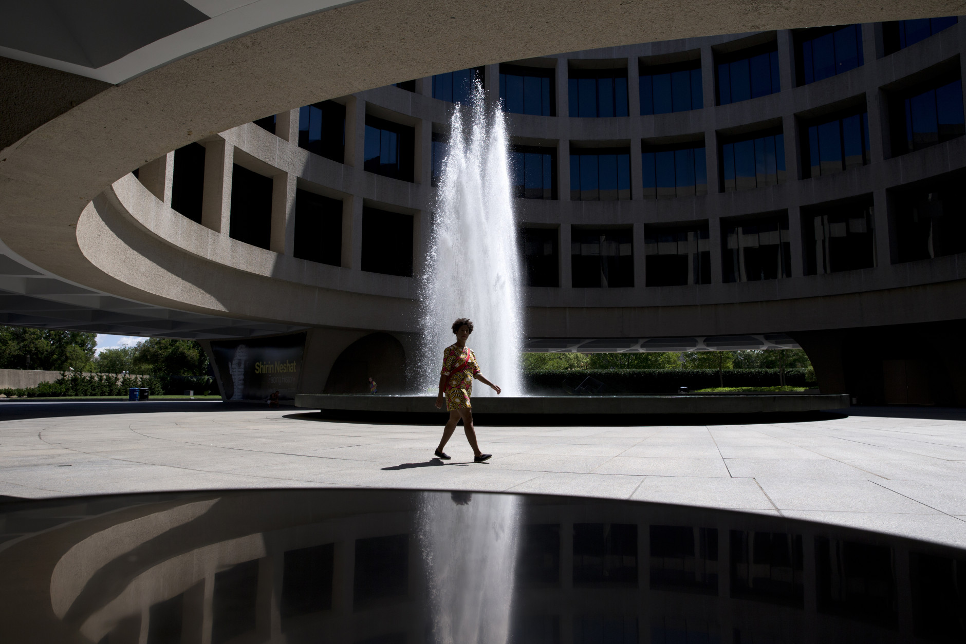 A woman walks past the fountain in the courtyard of the Hirshhorn Museum and Sculpture Garden in Washington, Thursday, Aug. 13, 2015. (AP Photo/Carolyn Kaster)