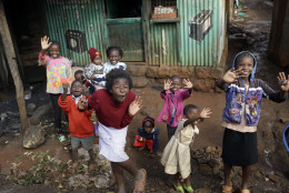 Children cheer and wave during Pope Francis' visit to the Kangemi slum, in Nairobi, Kenya, Friday, Nov. 27, 2015. Pope Francis denounced the conditions slum-dwellers are forced to live in during a visit to one of Nairobi's many shantytowns Friday, saying that access to safe water is a basic human right and that everyone should have dignified, adequate housing. (AP Photo/Andrew Medichini)