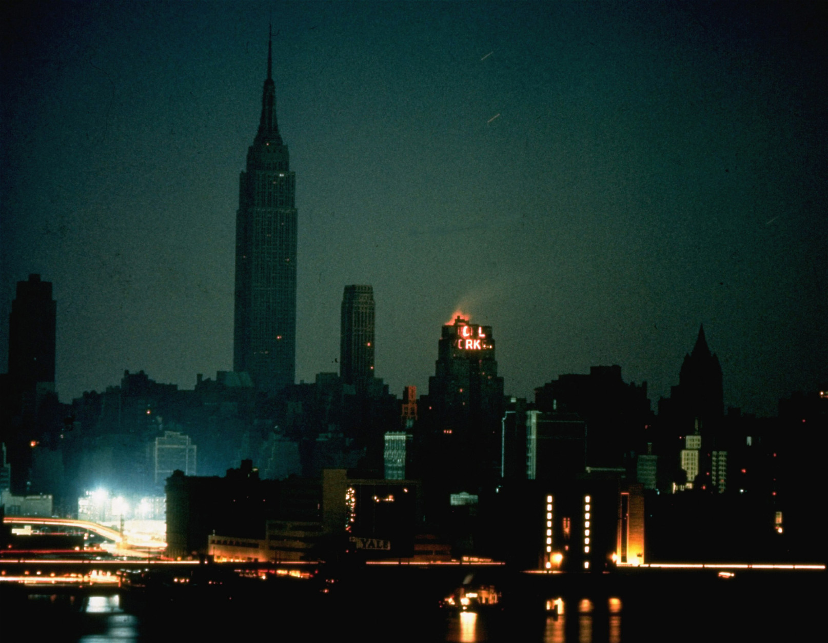 FILE - In this Nov. 9, 1965, file photo, New York City is seen in darkness from the Queens neighborhood of Long Island City during a power failure that left most of the northeastern United States and parts of Canada without power for hours. The buildings with lights had emergency power generators. (AP Photo/File)