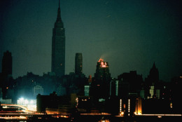 FILE - In this Nov. 9, 1965, file photo, New York City is seen in darkness from the Queens neighborhood of Long Island City during a power failure that left most of the northeastern United States and parts of Canada without power for hours. The buildings with lights had emergency power generators. (AP Photo/File)