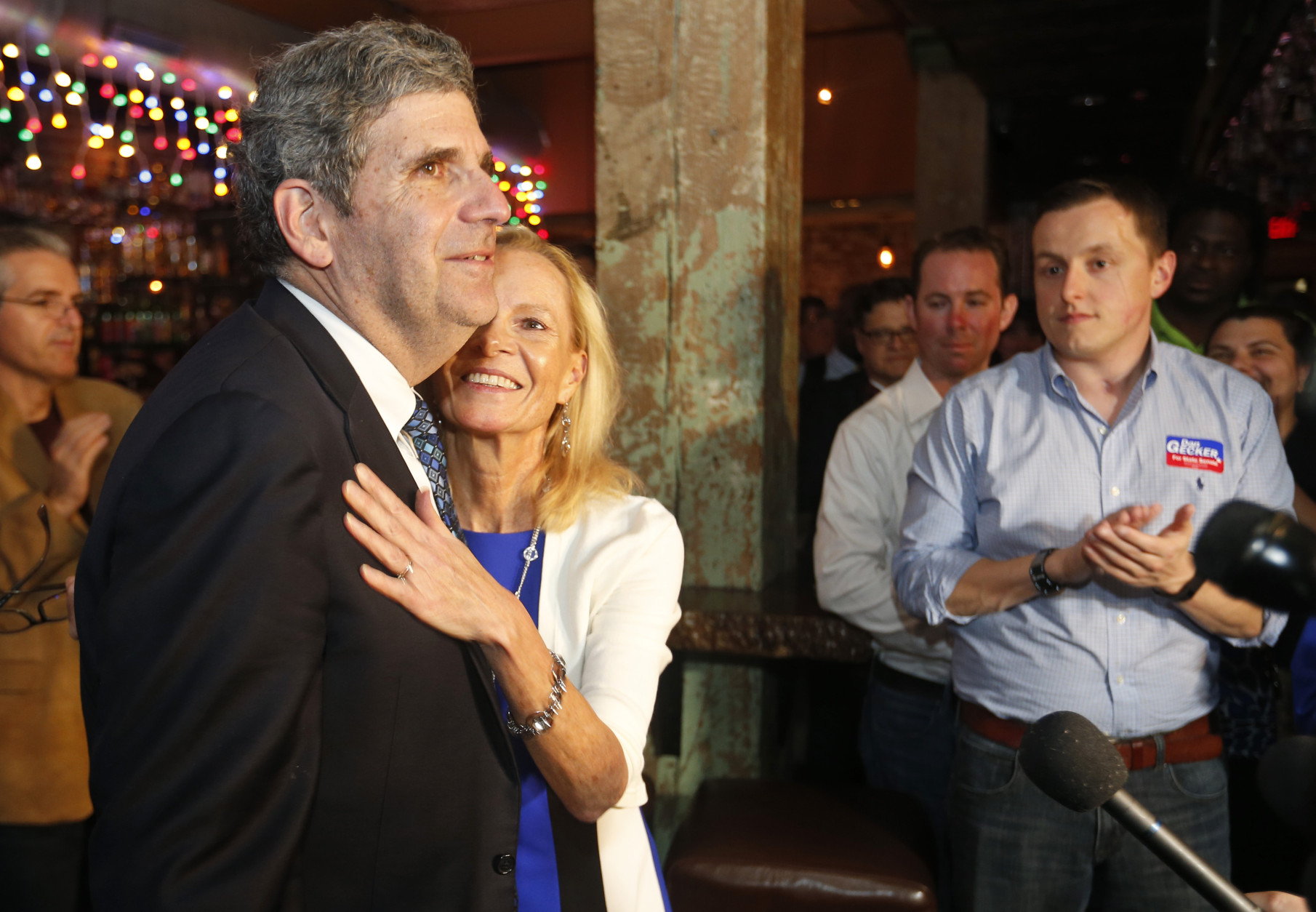 Democrat Dan Gecker gets a hug form his wife, Liz, as he speaks to a crowd of supporters at an election party in Richmond, Va., Tuesday, Nov. 3, 2015. Republican Glen Sturtevant narrowly defeated Gecker to hold a seat currently held by retiring GOP Sen. John Watkins. (AP Photo/Steve Helber)