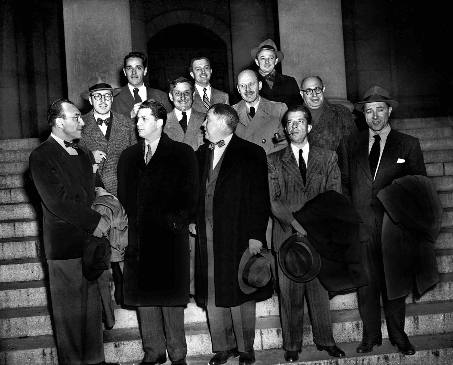 Ten Hollywood personalities, the "Hollywood 10," stand with their attorneys outside district court in Washington, D.C., Jan. 9, 1948 before arraignment on contempt of Congress charges.  From left, front: Herbert Biberman, Attorney Martin Popper, Attorney Robert W. Kenny, Albert Maltz and Lester Cole.  Second row, from left: Dalton Trumbo, John Howard Lawson, Alvah Bessie and Samuel Ornitz.  Top row, from left: Ring Lardner Jr., Edward Dmytryk and Adrian Scott. The ten were charged for refusing to cooperate with the House Un-American Activities Committee. (AP Photo)