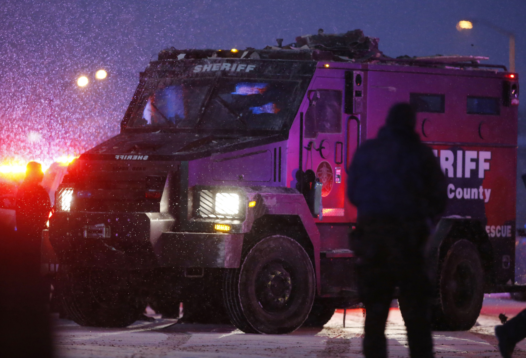A police vehicle, carrying a suspect, is lead away after a shooting at a Planned Parenthood clinic Friday, Nov. 27, 2015, in Colorado Springs, Colo. A gunman opened fire at the clinic on Friday, authorities said, wounding multiple people. (AP Photo/David Zalubowski)