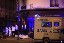 Medical staff stand by victims in a Paris restaurant, Friday, Nov. 13, 2015. Two police officials say at least 11 people have been killed in shootouts and other violence around Paris. Police have reported shootouts in at least two restaurants in Paris. At least two explosions have been heard near the Stade de France stadium, and French media is reporting of a hostage-taking in the capital. (AP Photo/Thibault Camus)