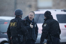 Police stand guard near a Planned Parenthood clinic Friday, Nov. 27, 2015, in Colorado Springs, Colo. A gunman opened fire at the clinic on Friday, authorities said, wounding multiple people. (AP Photo/David Zalubowski)