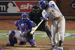 Kansas City Royals' Lorenzo Cain hits a three run double against the New York Mets during the 12th inning of Game 5 of the Major League Baseball World Series Monday, Nov. 2, 2015, in New York. (AP Photo/Charlie Riedel)