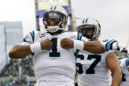 Carolina Panthers quarterback Cam Newton (1) reacts after he rushed for a touchdown in the first half of an NFL football game against the Seattle Seahawks, Sunday, Oct. 18, 2015, in Seattle. (AP Photo/Elaine Thompson)