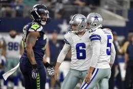Seattle Seahawks' Michael Bennett (72) walks by as Dallas Cowboys' Chris Jones (6) and Dan Bailey (5) celebrate a field goal kicked by Bailey in the first half of an NFL football game Sunday, Nov. 1, 2015, in Arlington, Texas. (AP Photo/Michael Ainsworth)