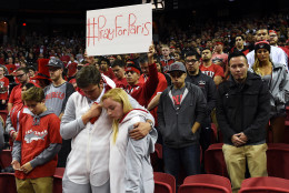 In this image made available by the Las Vegas News Bureau, UNLV fans observe a moment of silence for the victims of the terrorist attacks in Paris Friday, Nov. 13, 2015 before UNLV's basketball game against Cal Poly at the Thomas &amp; Mack Center in Las Vegas. (Sam Morris/Las Vegas News Bureau via AP)