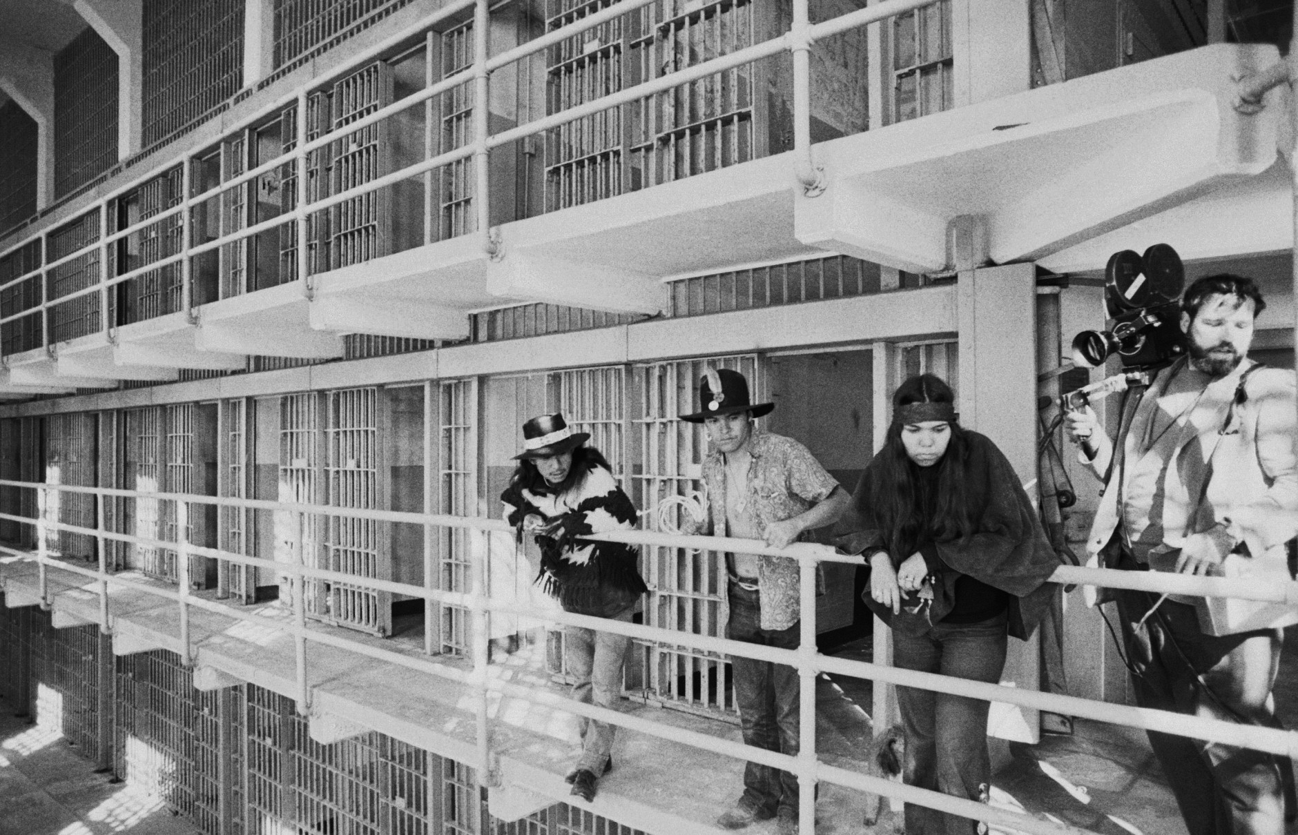 Part of a band of American Indians look over the main cell block of Alcatraz after occupying the island for the second time in two weeks in San Francisco on Nov. 19, 1969. The Indians say they want the island for a new Indian center to replace a San Francisco building destroyed by fire. The General Service Administration asked the Indians to leave but threatened no immediate action. (AP Photo/RWK)