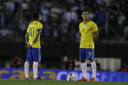 Brazil's Neymar, left, and Ricardo Oliveira observe a minutes of silence to pay their respects to the victims of attack that took place in Paris prior to a 2018 World Cup qualifying soccer match in Buenos Aires, Argentina, Friday, Nov. 13, 2015. Several dozen people were killed in attacks around Paris on Friday, French President Francois Hollande said, announcing that he was closing the countrys borders and declaring a state of emergency. (AP Photo/Victor R. Caivano)