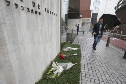 Flowers are laid outside the French Embassy in Tokyo, Saturday, Nov. 14, 2015, after machine guns and explosions killed over 100 in attacks across Paris, France, on Friday, Nov. 13. (AP Photo/Koji Sasahara)