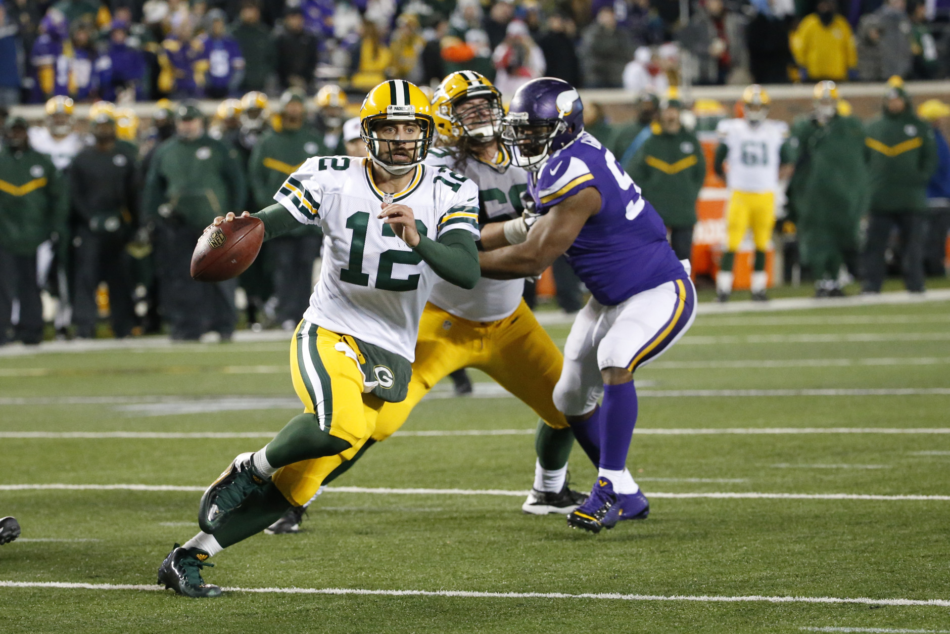 Green Bay Packers quarterback Aaron Rodgers (12) scrambles against the Minnesota Vikings during the second half of an NFL football game in Minneapolis, Sunday, Nov. 22, 2015. (AP Photo/Ann Heisenfelt)