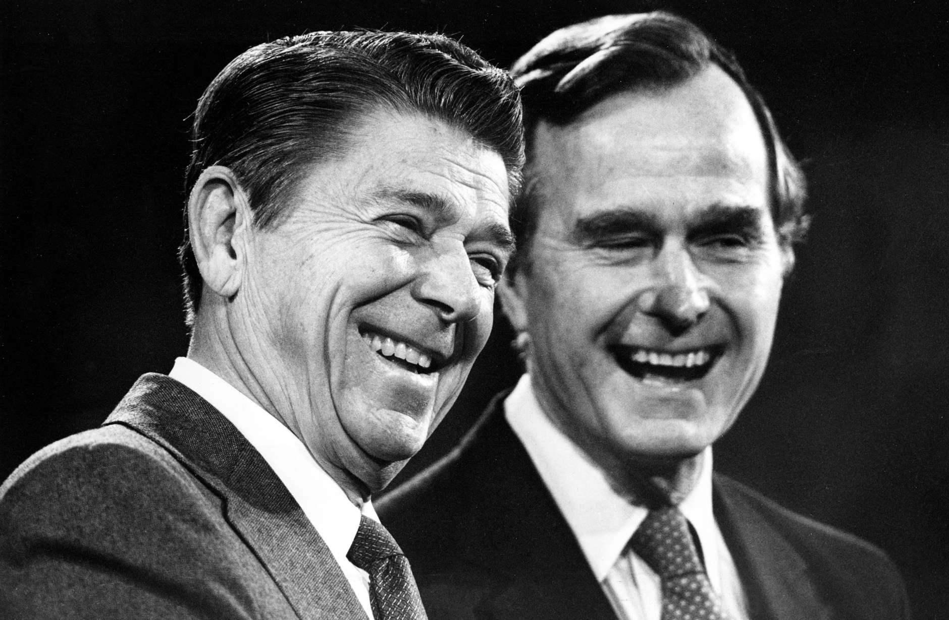 U.S. President-elect Ronald Reagan, left, and Vice President-elect George Bush share a laugh during their first news conference in which they announced their transitional team in Los Angeles, Ca., Nov. 6, 1980.  (AP Photo)