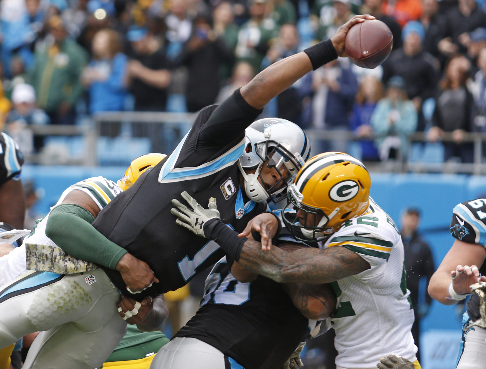 Carolina Panthers' Cam Newton (1) reaches the ball over the goal line for a touchdown against the Green Bay Packers in the first half of an NFL football game in Charlotte, N.C., Sunday, Nov. 8, 2015. (AP Photo/Bob Leverone)