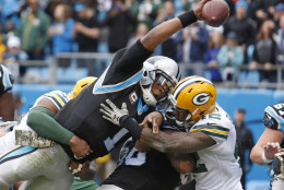 Carolina Panthers' Cam Newton (1) reaches the ball over the goal line for a touchdown against the Green Bay Packers in the first half of an NFL football game in Charlotte, N.C., Sunday, Nov. 8, 2015. (AP Photo/Bob Leverone)
