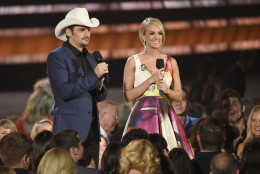 Brad Paisley, left, and Carrie Underwood speak at the 49th annual CMA Awards at the Bridgestone Arena on Wednesday, Nov. 4, 2015, in Nashville, Tenn. (Photo by Chris Pizzello/Invision/AP)