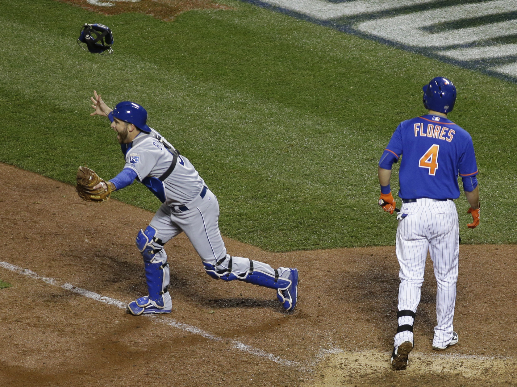 Kansas City Royals catcher Drew Butera celebrates after New York Mets' Wilmer Flores (4) struck out to end Game 5 of the Major League Baseball World Series against the New York Mets Monday, Nov. 2, 2015, in New York. The Royals won 7-2 to win the series. (AP Photo/Matt Slocum)