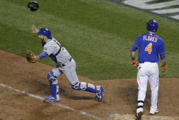 Kansas City Royals catcher Drew Butera celebrates after New York Mets' Wilmer Flores (4) struck out to end Game 5 of the Major League Baseball World Series against the New York Mets Monday, Nov. 2, 2015, in New York. The Royals won 7-2 to win the series. (AP Photo/Matt Slocum)