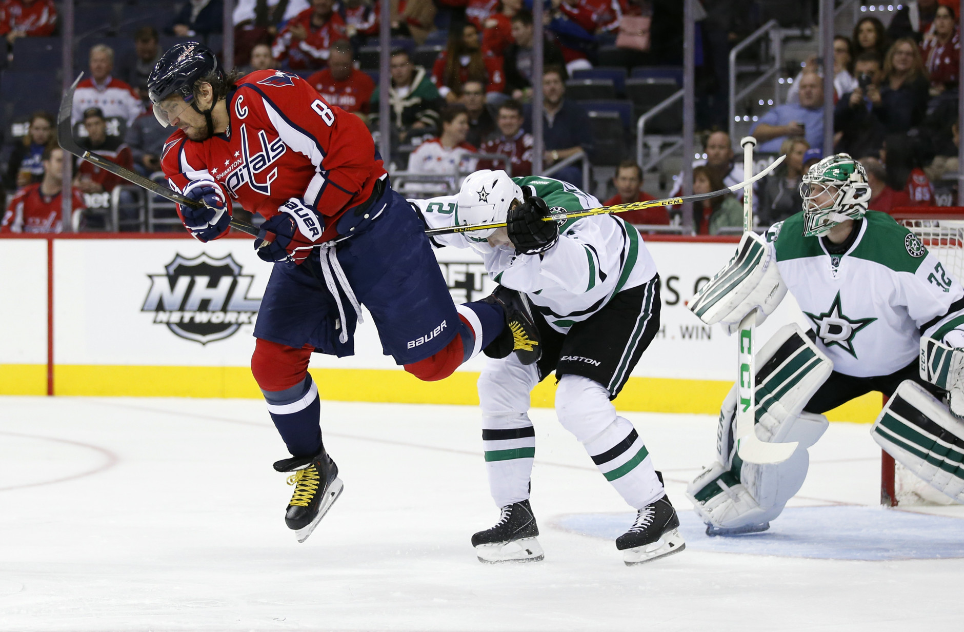 Washington Capitals left wing Alex Ovechkin (8), from Russia, is knocked from his skates by Dallas Stars defenseman Jyrki Jokipakka (2), from Finland, during the first period of an NHL hockey game, Thursday, Nov. 19, 2015, in Washington. (AP Photo/Alex Brandon)