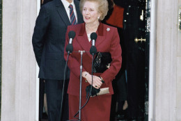 Margaret Thatcher and her husband Denis talks with reporters on the steps of No. 10 Downing Street, Westminster on Wednesday, Nov. 28, 1990 shortly before she made the short journey to Buckingham Palace to resign as Prime Minister to Queen Elizabeth. Thatcher, 65, stepped down after 11? years as leader John Major; her Chancellor of the Exchequer will take office following her resignation. (AP Photo/Martin Cleaver)