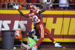 Kansas City Chiefs defensive back Marcus Peters (22) celebrates his interception of a pass by Denver Broncos quarterback Peyton Manning for a touchdown during the first half of an NFL football game in Kansas City, Mo., Thursday, Sept. 17, 2015. (AP Photo/Ed Zurga)