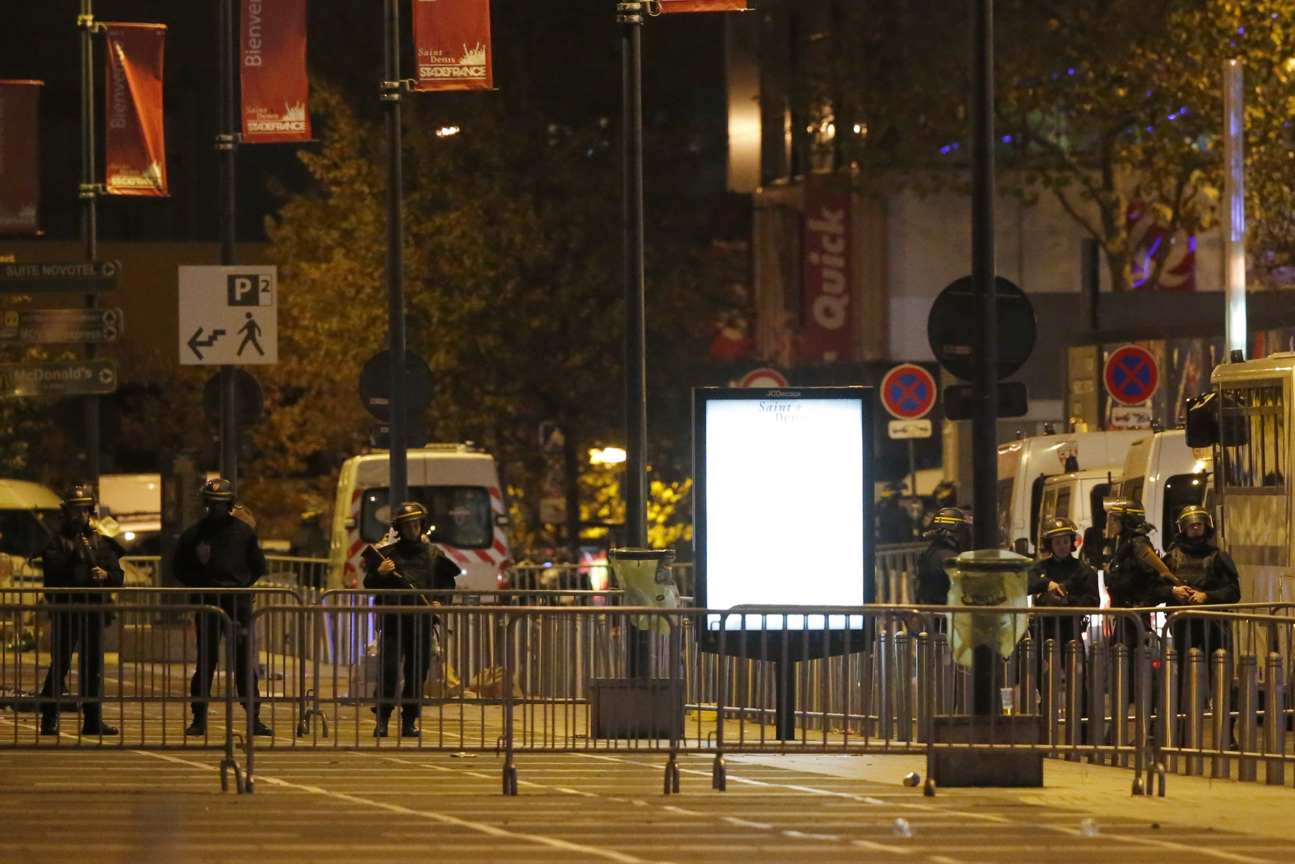 Police officers secure a street outside the Stade de France stadium after the international friendly soccer France against Germany, Friday, Nov. 13, 2015 in Saint Denis, outside Paris. Two police officials say that at least 26 people have been killed in shootings and explosions around Paris, in the deadliest violence in France in decades. (AP Photo/Michel Euler)