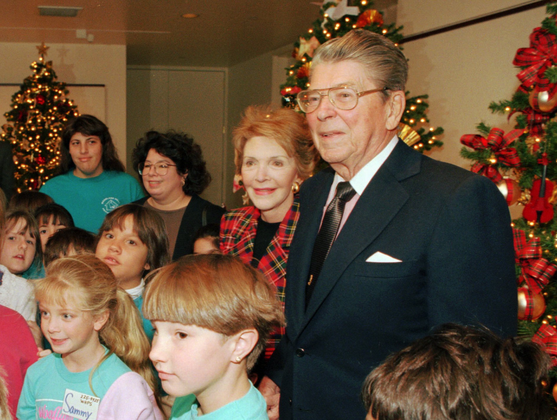 Former President Ronald Reagan and his wife Nancy pose for pictures during a tour of the "Christmas Around the World" exhibit at the Ronald Reagan Presidential Library and Museum Tuesday, Nov. 22, 1994, in Simi Valley, Calif.  The event marked the former President's first public appearance since the Nov. 5, 1994, public announcement that he has been diagnosed with Alzheimer's disease.  The disease seems to have silenced Reagan, who cherished the moments he spent spinning yarns about Hollywood andthe White House.  (AP Photo/Mark J. Terrill)