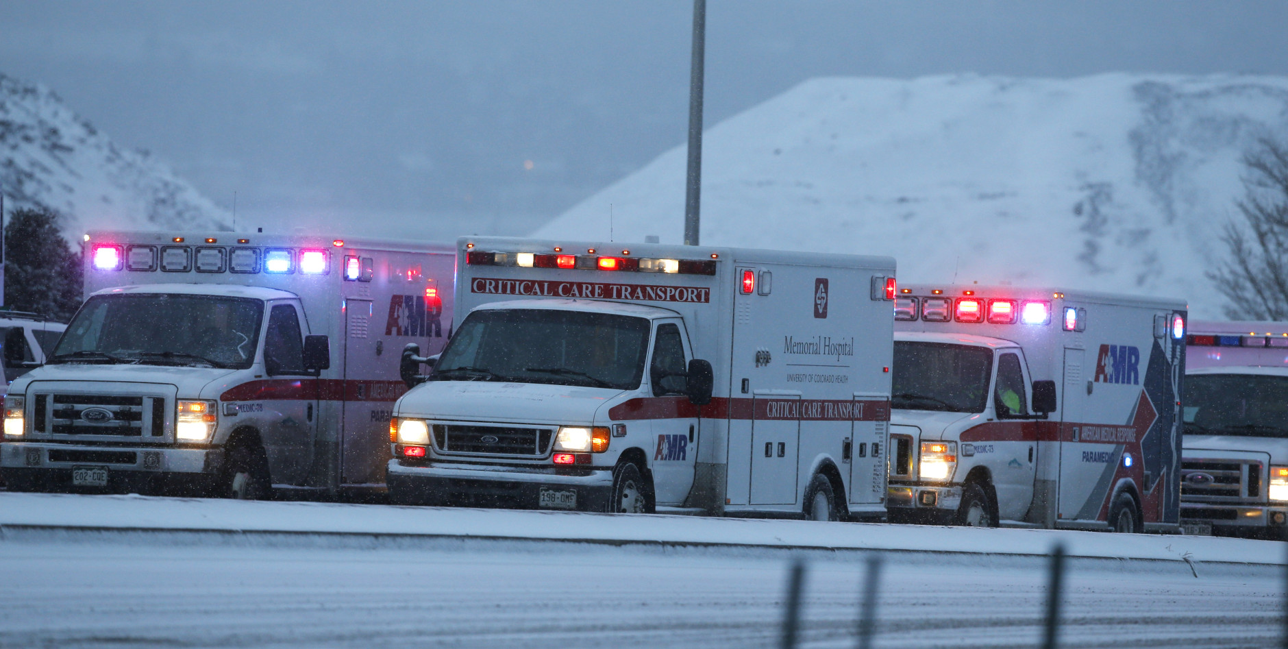 Ambulances wait to be directed near intersection of Centennial and Fillmore near a Planned Parenthood clinic Friday, Nov. 27, 2015, in Colorado Springs, Colo. A gunman opened fire at the clinic on Friday, authorities said, wounding multiple people. (AP Photo/David Zalubowski)