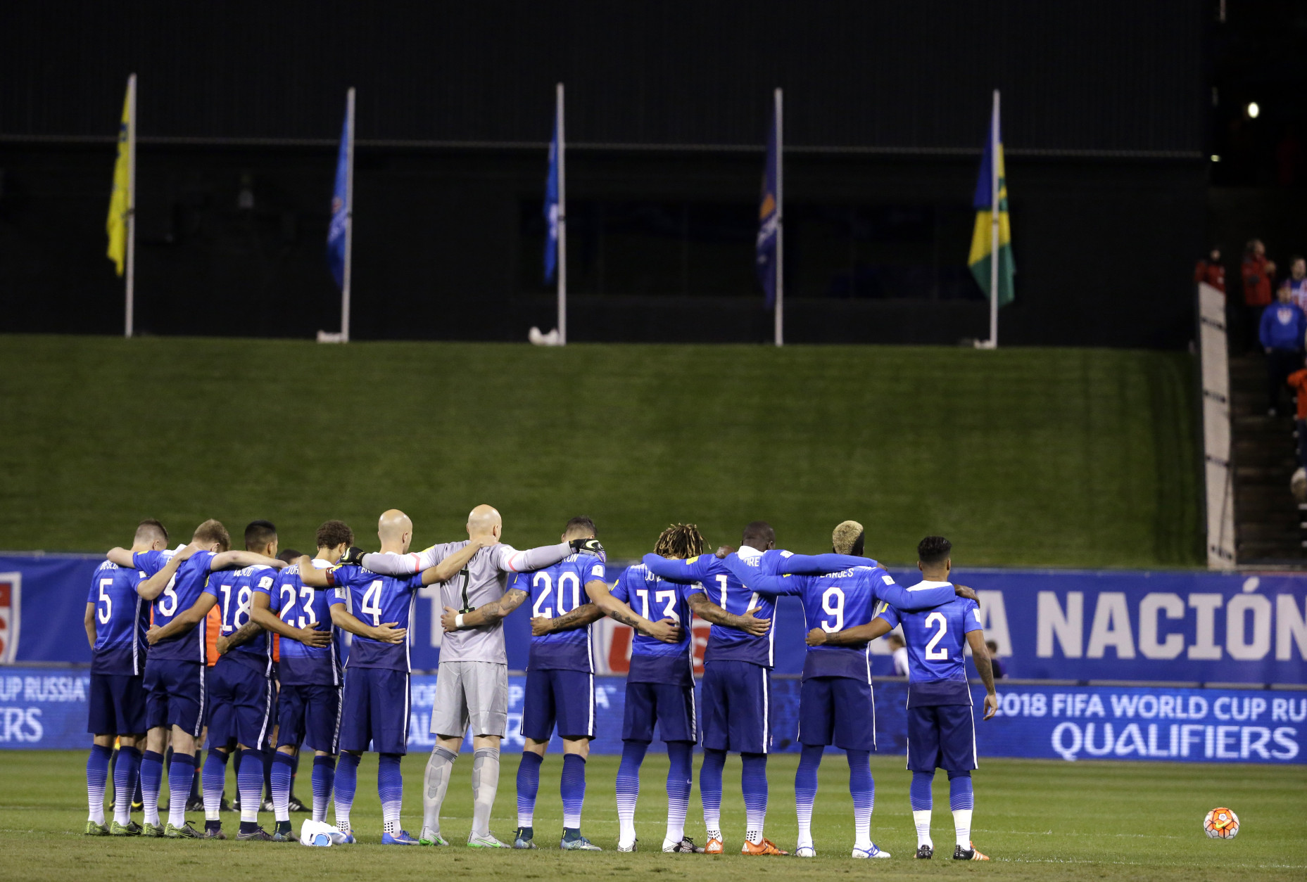 Members of the United States men's national soccer team pauses for a moment of silence to reflect on the events in Paris before the start of a 2018 World Cup qualifying soccer match against St. Vincent and the Grenadines Friday, Nov. 13, 2015, in St. Louis. The United States won 6-1. (AP Photo/Jeff Roberson)