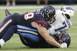 HOUSTON, TX - NOVEMBER 01: Zach Mettenberger #7 of the Tennessee Titans is sacked by J.J. Watt #99 and Jared Crick #93 of the Houston Texans in the third  quarter on November 1, 2015 at NRG Stadium in Houston, Texas. The Texans won 20 to 6. (Photo by Thomas B. Shea/Getty Images)