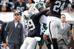 OAKLAND, CA - NOVEMBER 01:  Charles Woodson #24 of the Oakland Raiders intercepts a pass intended for Brandon Marshall #15 of the New York Jets during their NFL game at O.co Coliseum on November 1, 2015 in Oakland, California.  (Photo by Ezra Shaw/Getty Images)