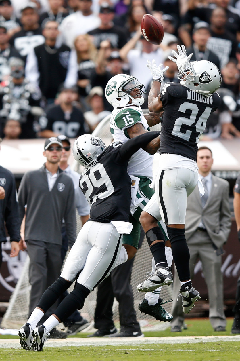 OAKLAND, CA - NOVEMBER 01:  Charles Woodson #24 of the Oakland Raiders intercepts a pass intended for Brandon Marshall #15 of the New York Jets during their NFL game at O.co Coliseum on November 1, 2015 in Oakland, California.  (Photo by Ezra Shaw/Getty Images)